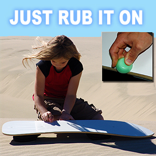 Young girl waxing her sandboard.